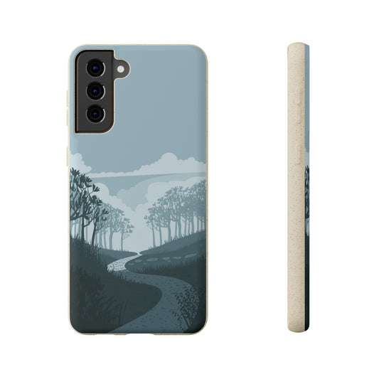 The Wanderlust Biodegradable Phone Case by Printify features a minimalist nature-inspired design with a winding path through trees and clouds, shown from the back and side on a neutral background.